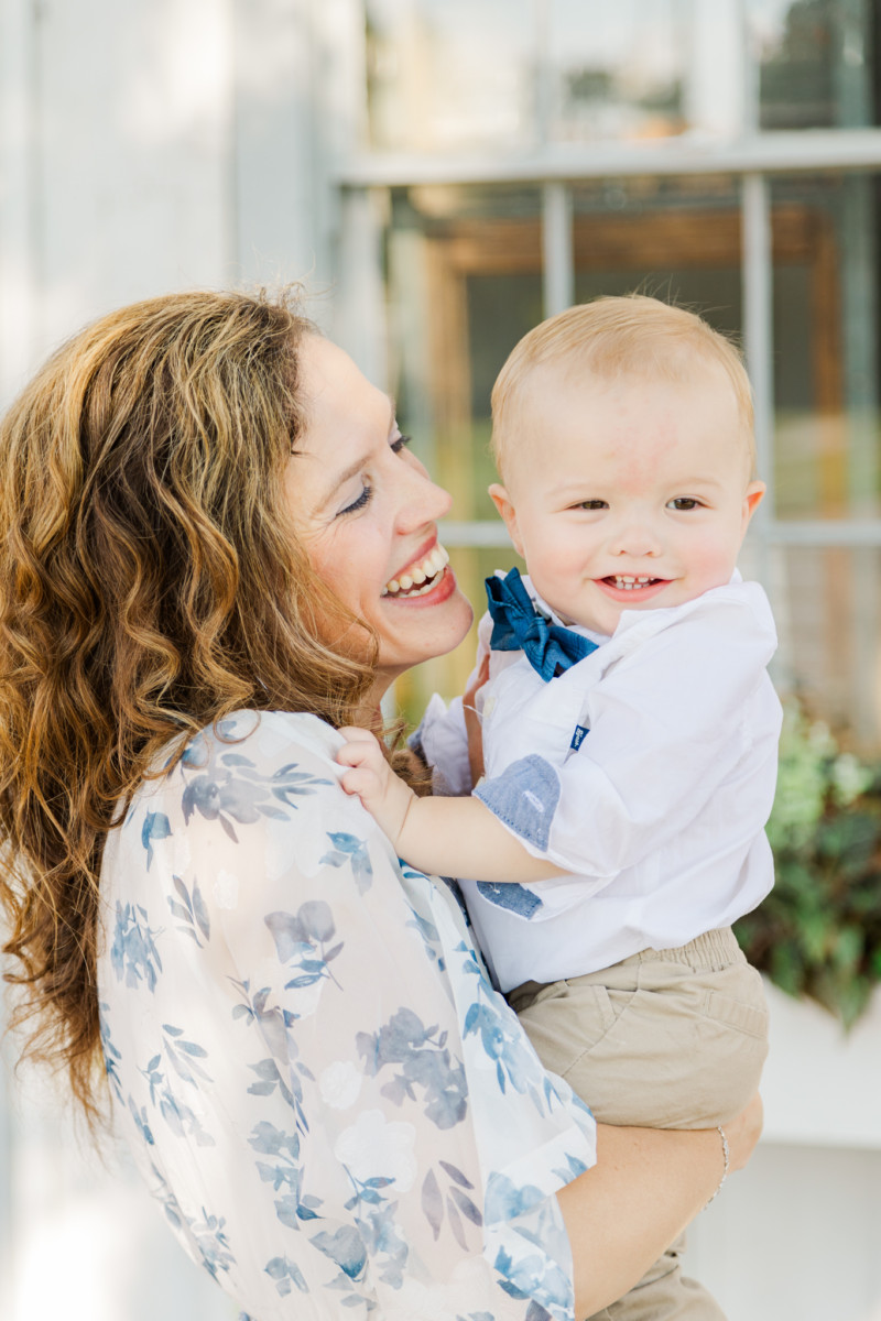 mom smiles at baby for saline family photographer at saline depot museum