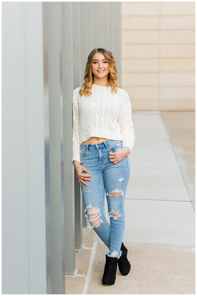 girl standing outside u of m museum of art smiling at the camera