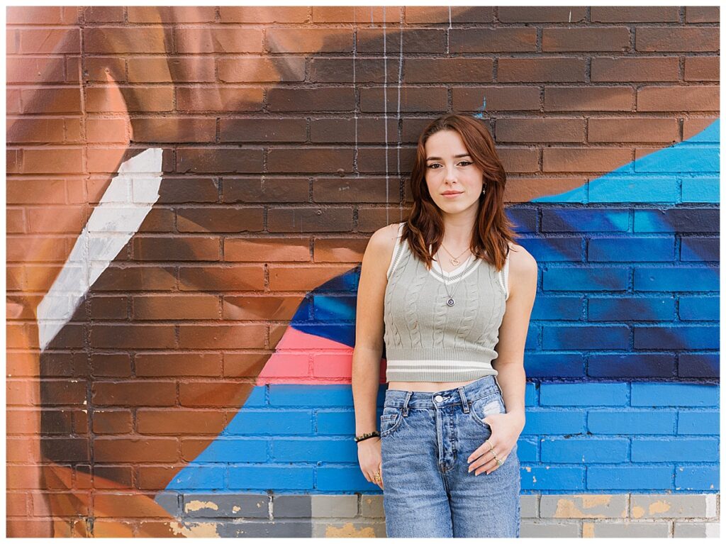 Girl standing against a graffiti wall in Ann Arbor