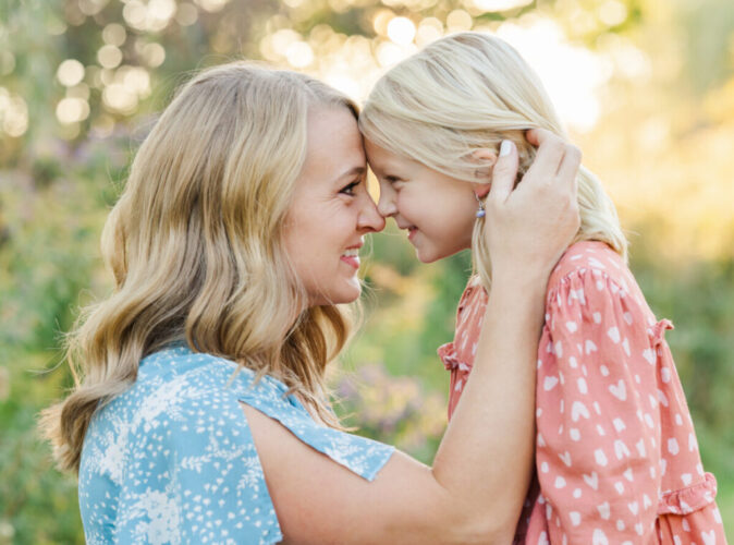 Michigan family photographer shows a woman nose to nose with a little girl