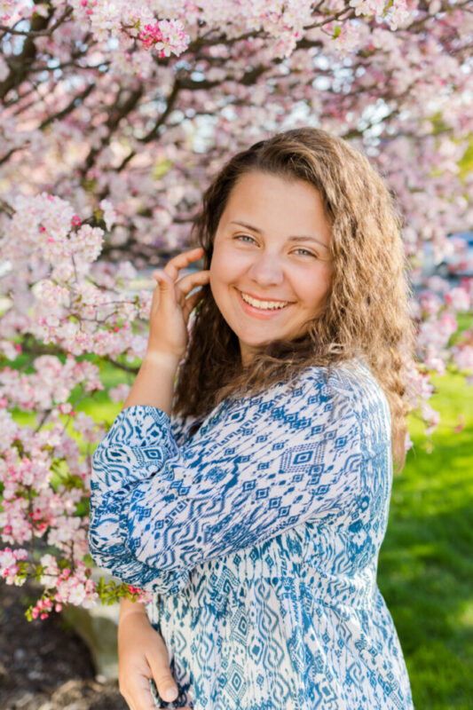 Senior girl surrounded by a blooming tree