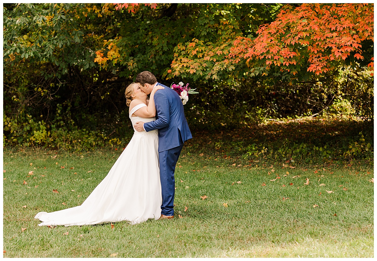 bride and groom kiss during first look pictures