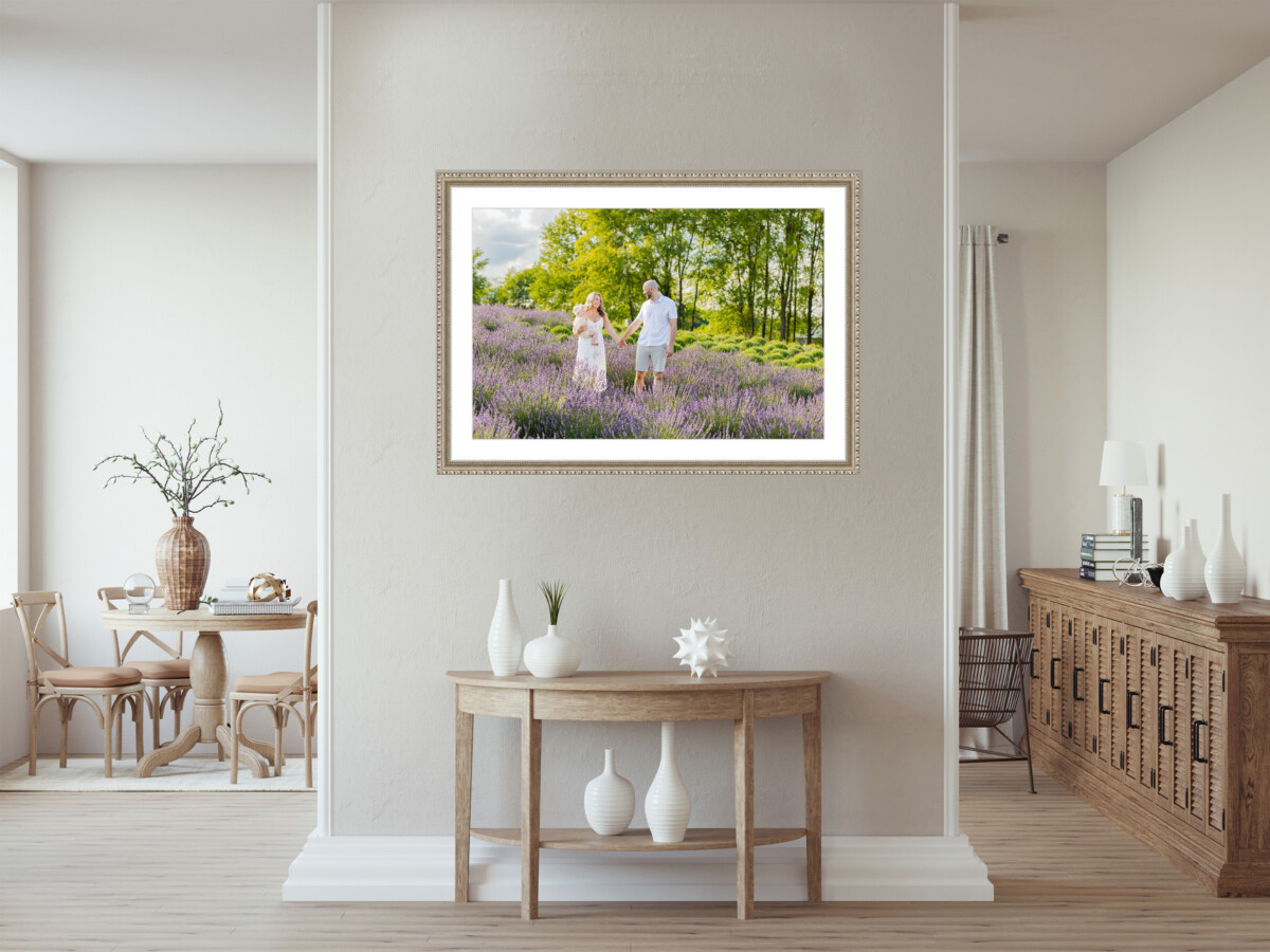 A picture hangs above a console table on a dividing wall. 