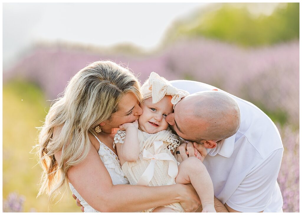 Parents kiss baby while taking photos at Belle Lavande 