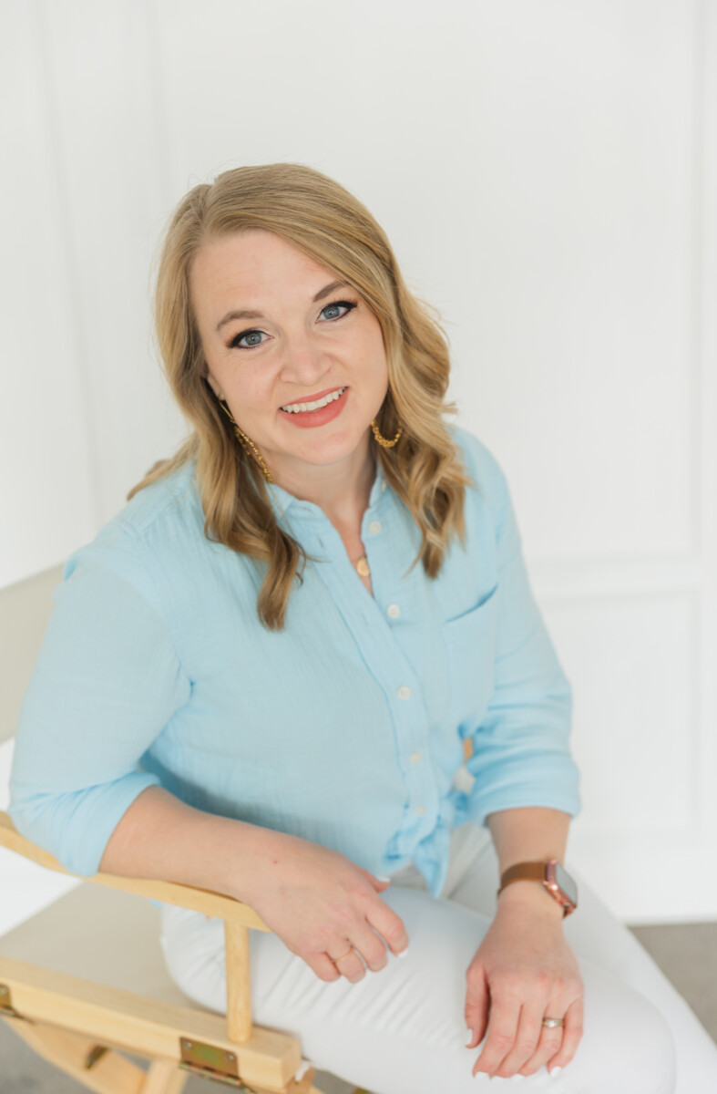 Woman sitting in a chair smiling at the camera- Stacy Anderson Photography