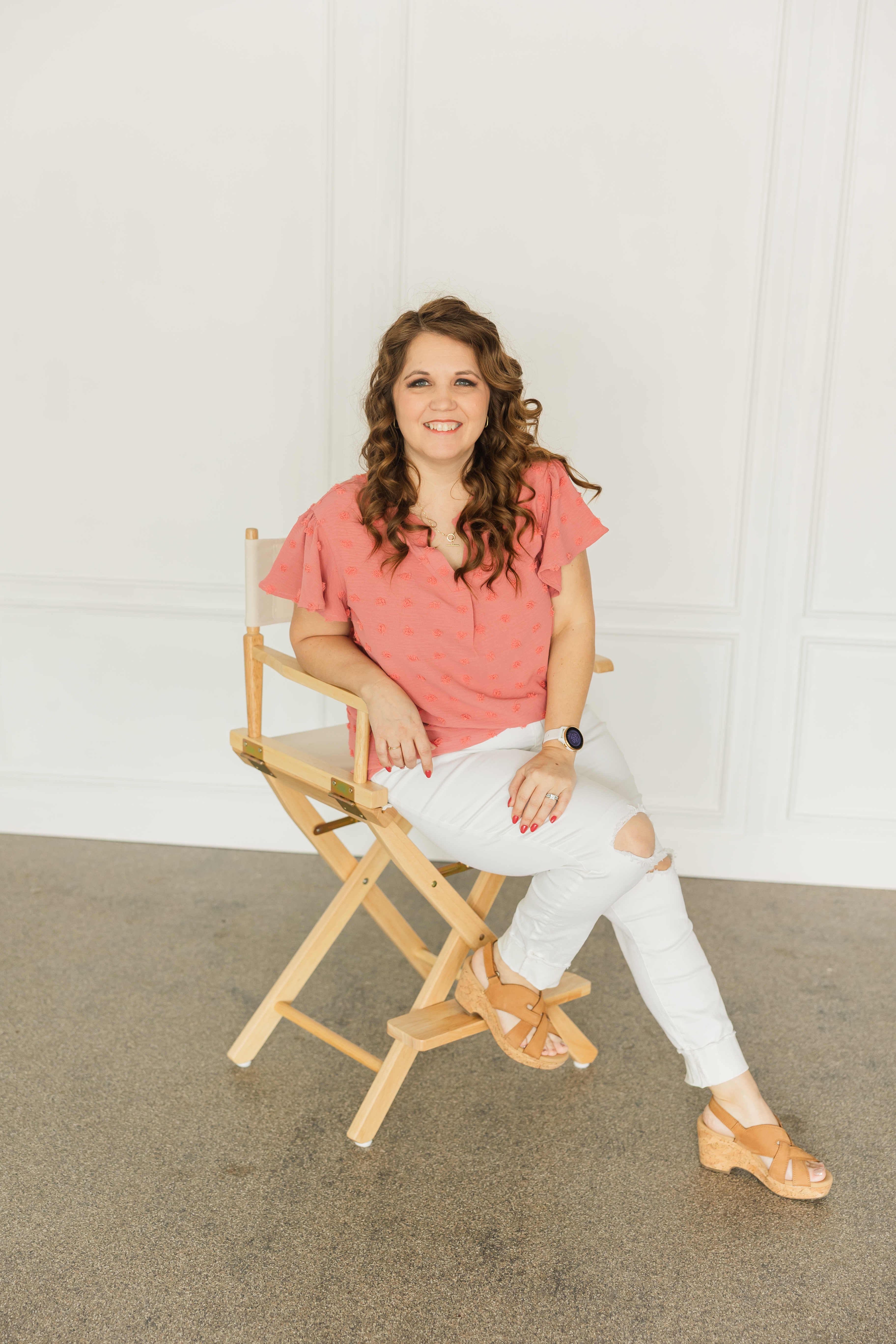 woman sitting in a chair smiling at the camera